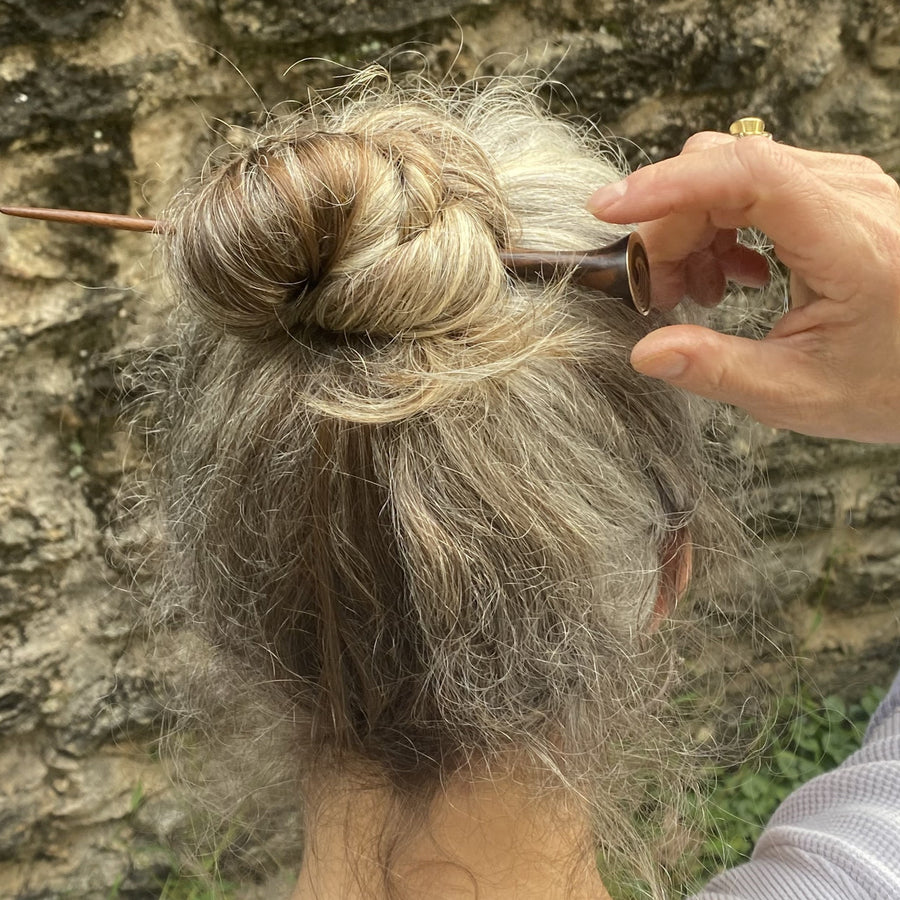 An example of using the hair stick to hold up your long hair.